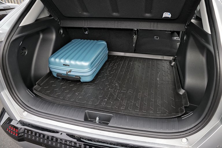 Bagagerum med blå kuffert i en Hyundai Kona